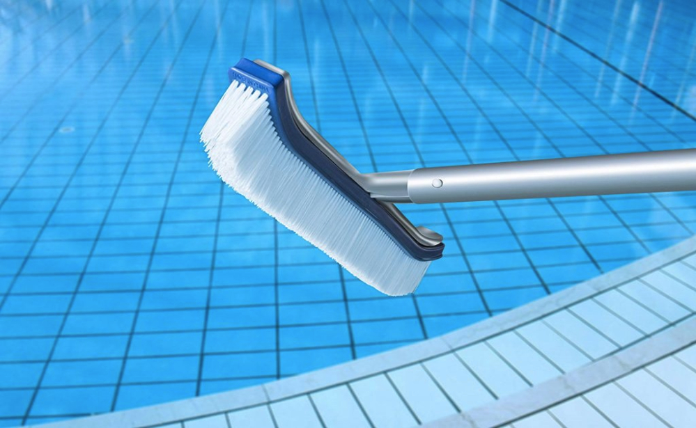 Pool brush used by a professional pool cleaner for outdoor and indoor pools