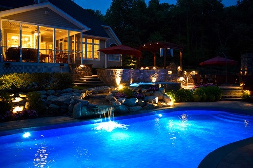 Luxurious outdoor lighting around the home and inside the pool in Cold Spring NY