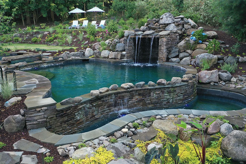 Luxurious pool with waterfalls and surrounded by beautiful landscape