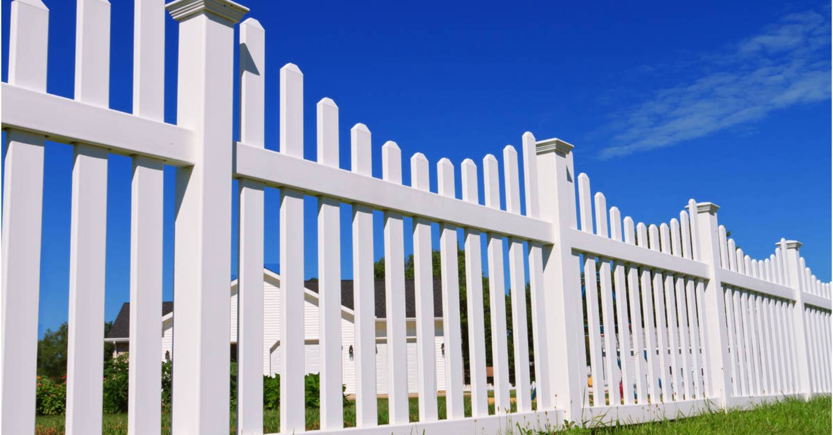 White wooden fence surrounding the landscape of the property